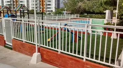a white fence in front of a swimming pool at Habitación Colibrí in Barranquilla