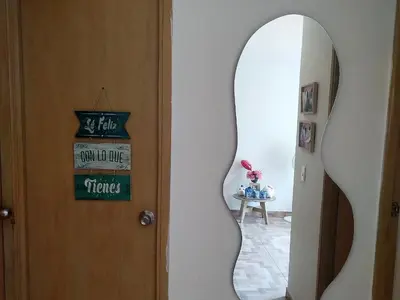 a door with a mirror next to a table at La casita de jo in Cartagena de Indias