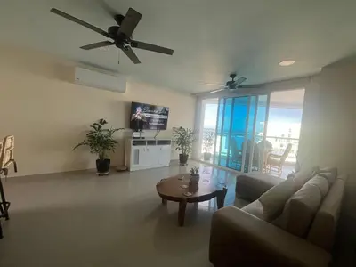 a living room with a couch and a ceiling fan at Lux Oceanfront Apartment in Cartagena de Indias
