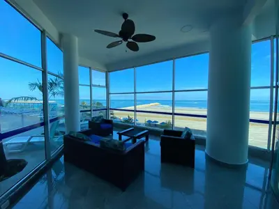 a living room with a ceiling fan and a view of the ocean at Apto Luxury cartagena 2401 Palmetto1 Frente al Mar in Cartagena de Indias