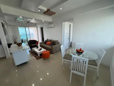 a living room with a table and a couch at Apto Luxury cartagena 2401 Palmetto1 Frente al Mar in Cartagena de Indias