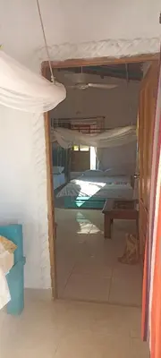 a room with two bunk beds and a table at Cabaña Flor de Loto in San Bernardo del Viento