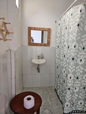 a bathroom with a shower curtain and a sink at Cabaña Flor de Loto in San Bernardo del Viento