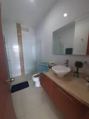 a bathroom with a sink and a toilet and a mirror at Apartamento Frente al Mar in Santa Marta