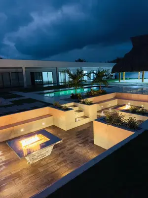 an outdoor patio with a fire pit at night at cabaña villa rags in Sabanagrande