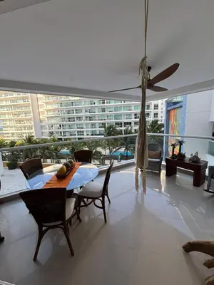 a dining room with a table and a ceiling fan at Beachfront Luxury Apartment Cartagena in Cartagena de Indias