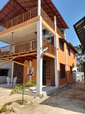 a large building with a balcony and a porch at Cabaña frente al mar de San Antero in San Antero