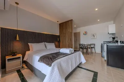 a bedroom with a bed and a kitchen and a television at Unbeatable Location -Exclusive Views- Clock Tower in Cartagena de Indias