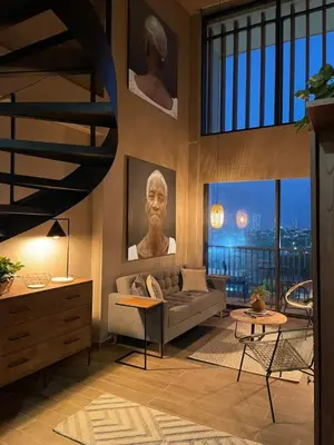 a living room with a couch and a large window at Artful Loft in the Heart of Historic Center in Cartagena de Indias