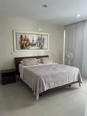 a bedroom with a large bed with a painting on the wall at Hermoso apartamento MORROS EPIC in Cartagena de Indias