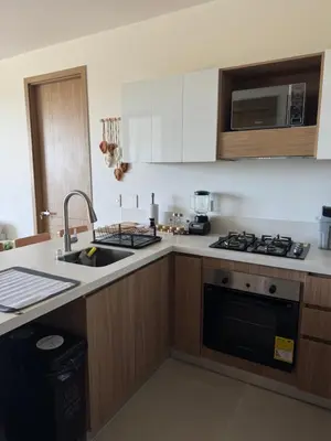 a kitchen with a sink and a stove top oven at Baia Kristal 5I in Estación El Salto
