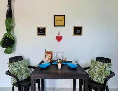 a dining room table with two chairs and a table with at Apartamento cerca a la playa in El Porvenir