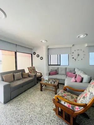 a living room with two couches and a table at Loft Vista al Laguito in Cartagena de Indias
