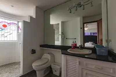 a bathroom with a sink and a toilet and a mirror at Apartamento frente al mar in Cartagena de Indias