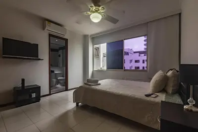 a bedroom with a bed and a large window at Apartamento frente al mar in Cartagena de Indias