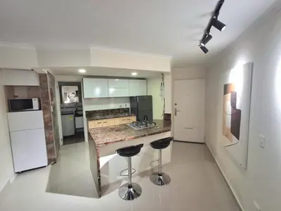a kitchen with a counter and two bar stools at Cabrero Beach 1213 in Cartagena de Indias