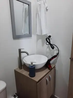 a bathroom with a sink and a mirror on a cabinet at Apartamento completo in Cartagena de Indias