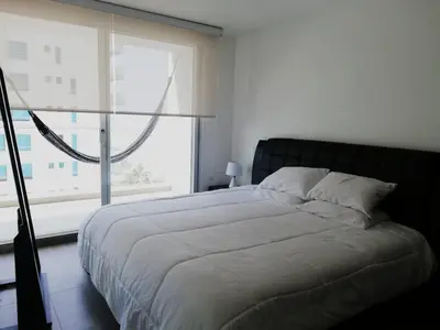 a bedroom with a bed and a large window at Apartamento con vista directa al mar en Spiaggia di Cartagena in Cartagena de Indias
