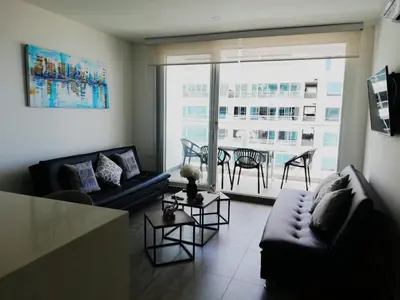 a living room with a couch and a table at Apartamento con vista directa al mar en Spiaggia di Cartagena in Cartagena de Indias