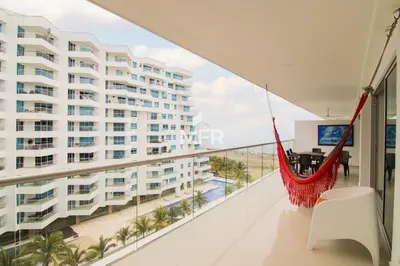 a hammock in a balcony with a view of a building at Morros Epic 2 Bedrooms Beachfront by Inmobiliaria MFR in Cartagena de Indias