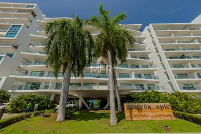 two palm trees in front of a large building at Morros Epic 2 Bedrooms Beachfront by Inmobiliaria MFR in Cartagena de Indias