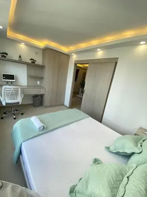 a bedroom with two beds and a desk at Terrazas Vista al Mar y Piscina Espectacular in Cartagena de Indias