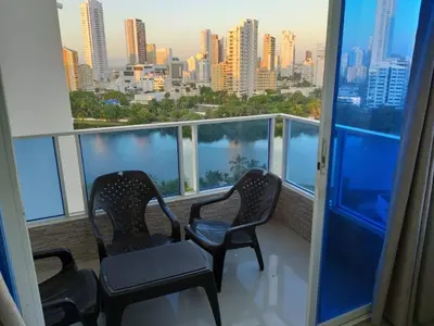 two chairs on a balcony with a view of the city at Apartamento Moderno con Vista - Piso 12 in Cartagena de Indias