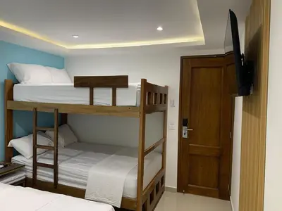 two bunk beds in a room with a door at Hotel Boulevard 58 in Galapa
