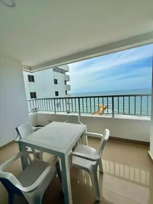 a balcony with a table and chairs and a view of the ocean at Apartamento con vista al mar Palmetto in Cartagena de Indias