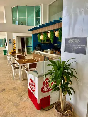 a restaurant with a coca cola machine and a plant at Apartamento con vista al mar Palmetto in Cartagena de Indias