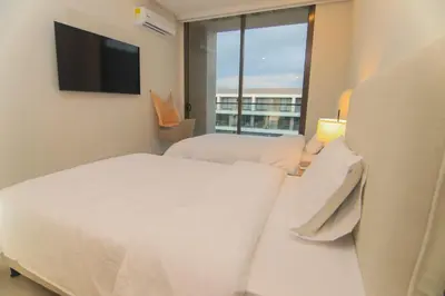 a bedroom with two beds and a flat screen tv at Exclusive Apartment With Ocean View By Huespedia in Cartagena de Indias