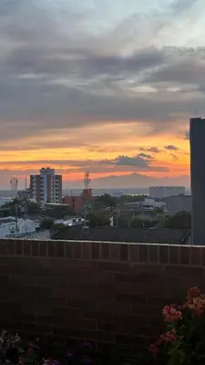 a sunset over a city with a brick wall at Apartamento Arrecife Golf in Barranquilla