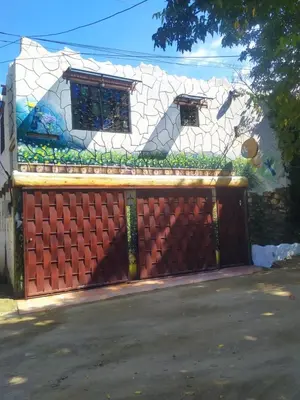 a house with a gate and a fence at Cabaña La Makuira in Santa Marta