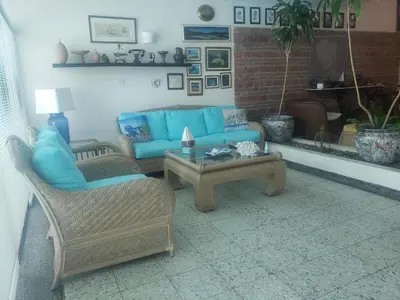 a living room with a blue couch and a table at Vista al Mar in Cartagena de Indias