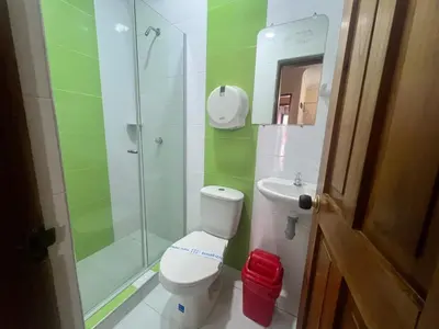 a bathroom with a shower and a toilet and a sink at Hotel Don Fermin in Barranquilla
