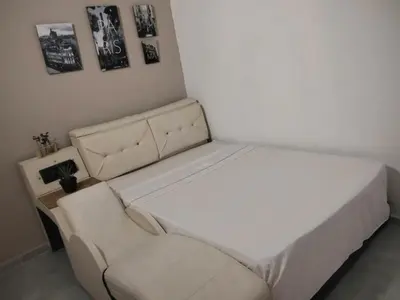 a white bed and a couch in a room at Hotel Boutique Tierra Del Mar Cartagena in Cartagena de Indias