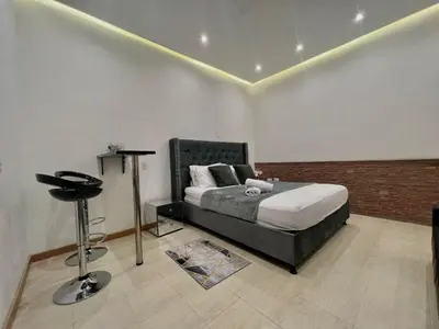 a bedroom with a bed and a stool in it at Cartagena Loft Independiente by Tico in Cartagena de Indias
