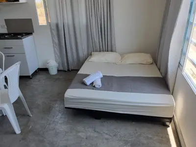a small bedroom with a bed with a roll on it at Apartahotel hm caribe in Santa Marta