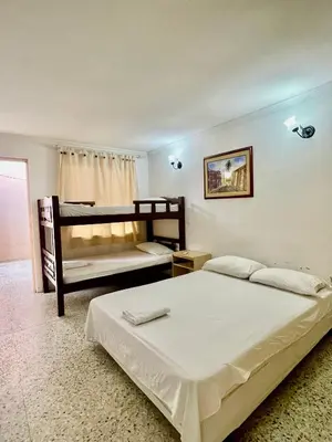 a bedroom with a bed and a bunk bed at Hotel Casa Fátima in Cartagena de Indias