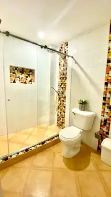 a bathroom with a toilet and a glass shower at Apartment in Old City Cartagena 3D in Cartagena de Indias