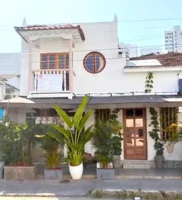 a white house with plants in front of it at Cartagena Hotel Boutique - Manga - Tierra del Mar - Colombia in Cartagena de Indias