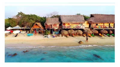 a beach with a group of buildings and the ocean at CARDUMEN ARTE y COCINA in Cartagena de Indias