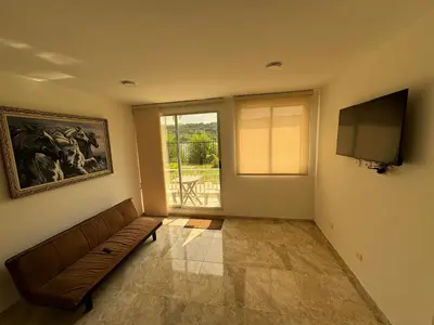a living room with a couch and a flat screen tv at Apartamento de una habitación en serena del mar en cartagena DAMMAR in Manzanillo del Mar