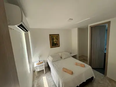 a small bedroom with a bed and a television at Apartamento de una habitación en serena del mar en cartagena DAMMAR in Manzanillo del Mar