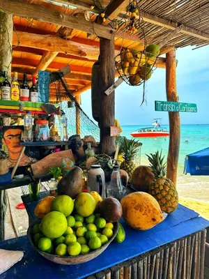 a table with a bunch of fruit on a beach at Beautiful Cabaña facing the Caribbean Sea! in Cartagena de Indias