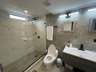 a bathroom with a toilet and a sink and a shower at Casa Martina Manga Cartagena in Cartagena de Indias