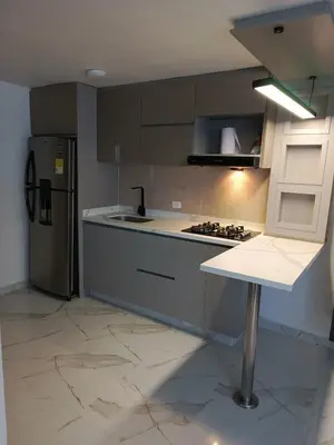 a kitchen with a stove and a refrigerator at Búho, alameda del río in Barranquilla