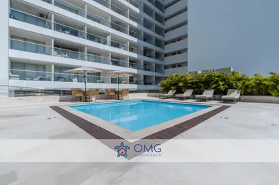 a swimming pool in front of a building at CB1622 | Suite frente al mar con balcón y piscina in Cartagena de Indias