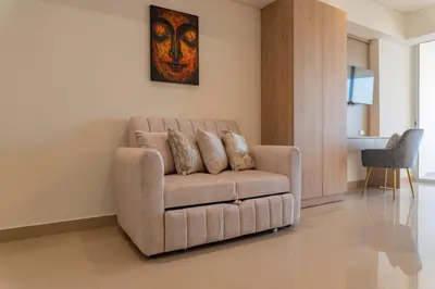 a brown couch sitting in a living room at Acogedora Suite Frente al Mar - Aeropuerto CB617 in Cartagena de Indias