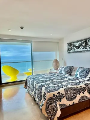 a bedroom with a bed with a view of the ocean at Beautiful 2 BR Ocean View Condo in Cartagena in Cartagena de Indias